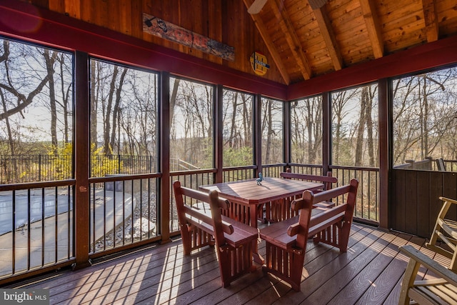 sunroom with a wealth of natural light and beamed ceiling