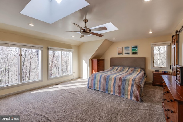 carpeted bedroom featuring visible vents, vaulted ceiling with skylight, ceiling fan, and recessed lighting