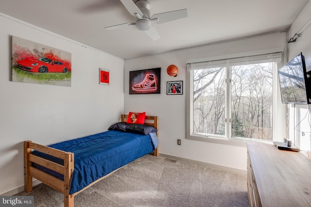 bedroom with baseboards, a ceiling fan, visible vents, and carpet