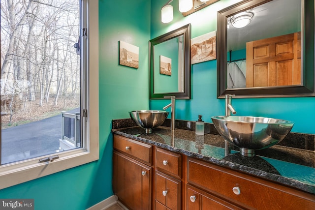 bathroom featuring double vanity and a sink