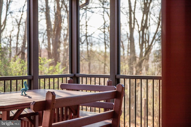 sunroom featuring outdoor dining area