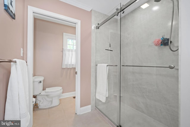 full bath featuring baseboards, tile patterned floors, a shower stall, and toilet