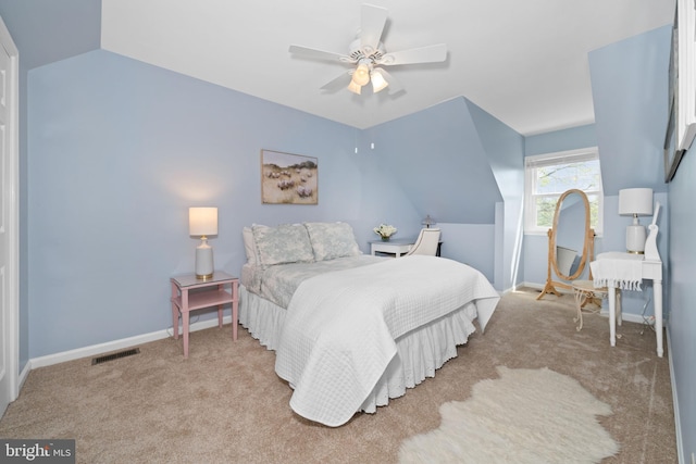 bedroom with ceiling fan, carpet floors, baseboards, vaulted ceiling, and visible vents