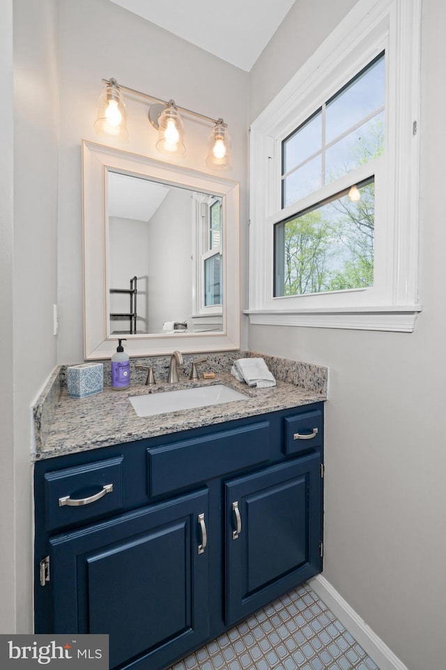 bathroom with vanity and baseboards