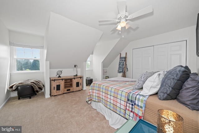 carpeted bedroom featuring a closet, a ceiling fan, lofted ceiling, and multiple windows