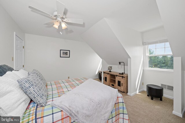 bedroom featuring a ceiling fan, baseboards, visible vents, and light carpet