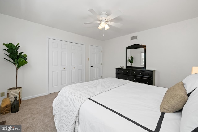 carpeted bedroom featuring a ceiling fan, baseboards, visible vents, and a closet