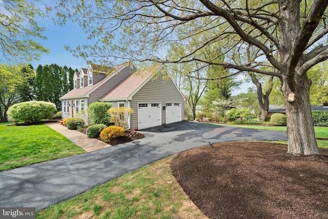 view of home's exterior with a lawn, an attached garage, and aphalt driveway