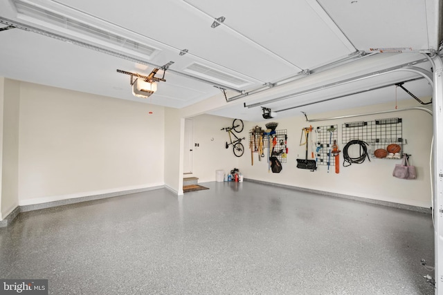 garage with baseboards and a garage door opener