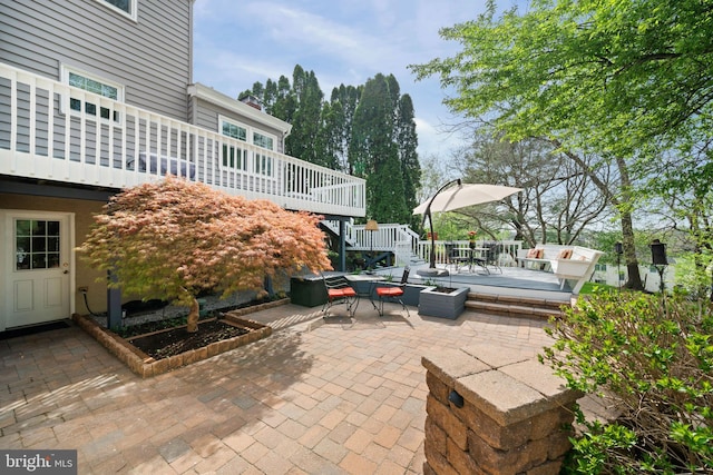 view of patio featuring a wooden deck, outdoor dining space, and stairs