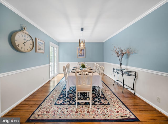 dining area with baseboards, ornamental molding, and hardwood / wood-style flooring