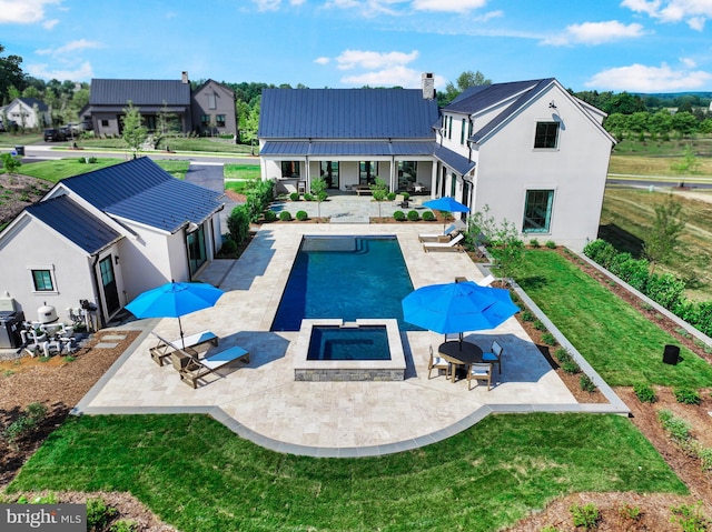 view of pool with a patio area and a lawn