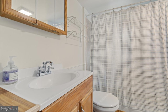 bathroom with toilet and vanity