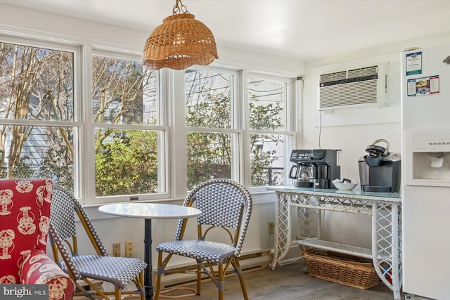 sunroom / solarium featuring an AC wall unit