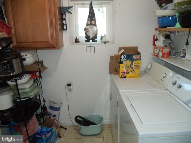 clothes washing area featuring separate washer and dryer, laundry area, and light tile patterned floors