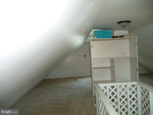 interior space featuring carpet floors and vaulted ceiling