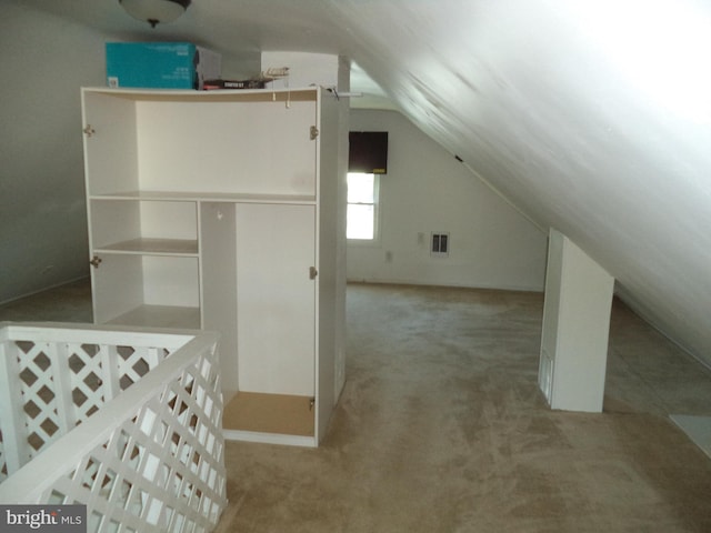 bonus room featuring visible vents, carpet flooring, and lofted ceiling