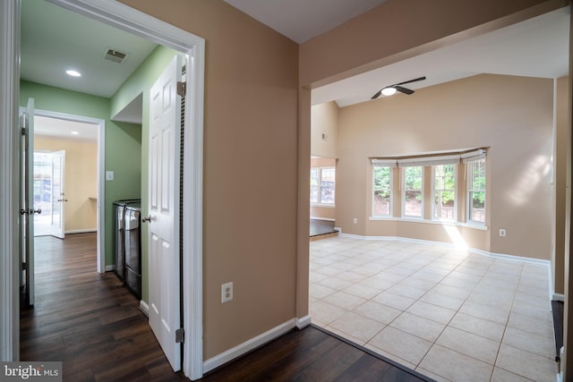 4501 Peppermill Ct, Dumfries, VA 22025 - hall with baseboards, dark wood-style floors, washer / dryer, and recessed lighting