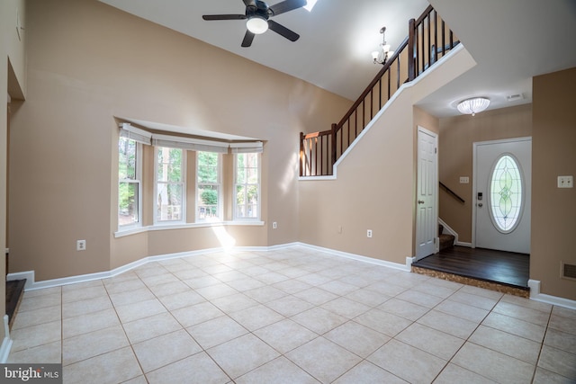 4501 Peppermill Ct, Dumfries, VA 22025 - foyer featuring stairway, light tile patterned floors, ceiling fan, high vaulted ceiling, and baseboards
