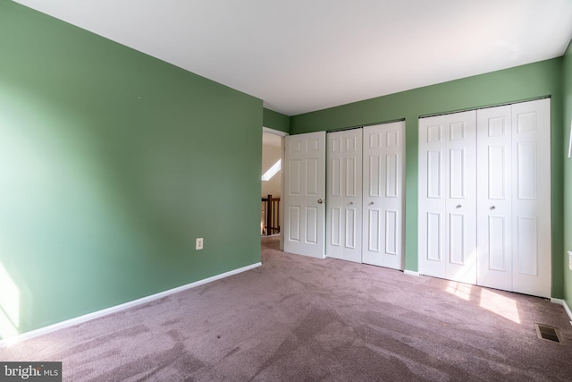 4501 Peppermill Ct, Dumfries, VA 22025 - unfurnished bedroom with carpet flooring, multiple closets, and baseboards