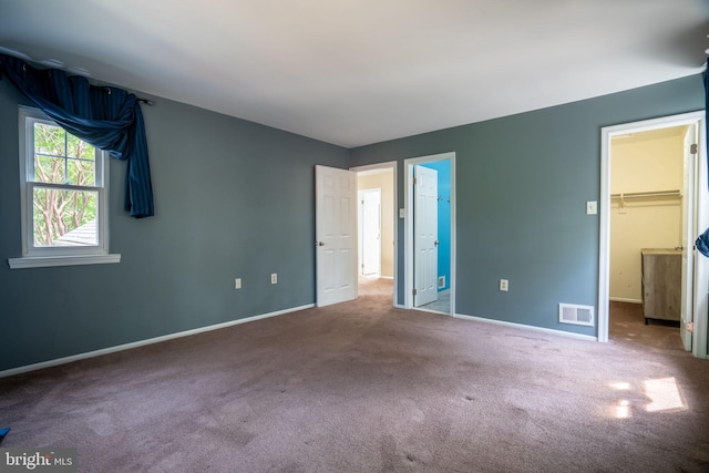 4501 Peppermill Ct, Dumfries, VA 22025 - unfurnished bedroom with carpet floors, a walk in closet, and baseboards