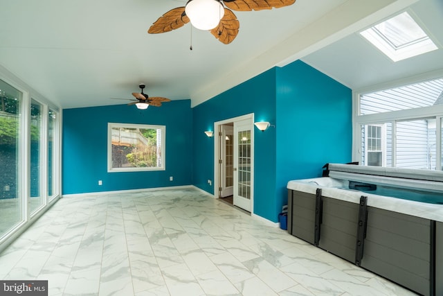 4501 Peppermill Ct, Dumfries, VA 22025 - interior space with vaulted ceiling, a ceiling fan, a skylight, light marble finish floors, and french doors