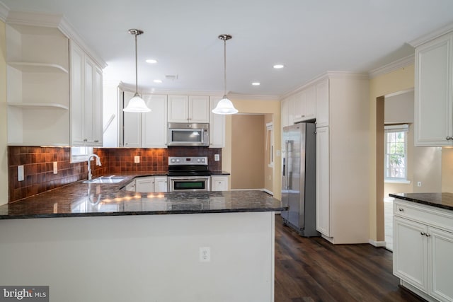 4501 Peppermill Ct, Dumfries, VA 22025 - kitchen with appliances with stainless steel finishes, a sink, decorative backsplash, a peninsula, and crown molding