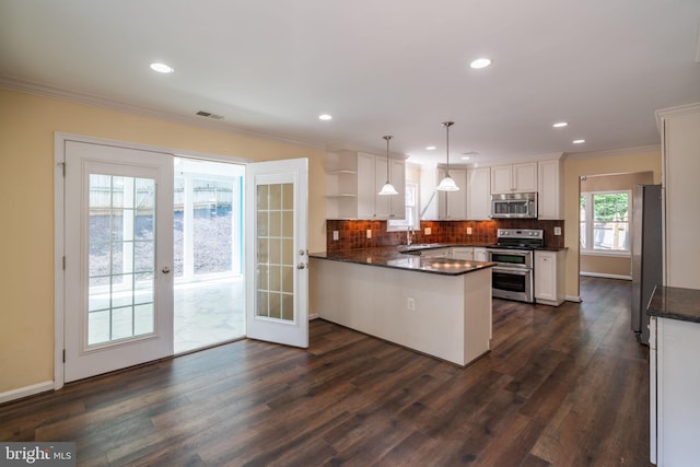 4501 Peppermill Ct, Dumfries, VA 22025 - kitchen with appliances with stainless steel finishes, open shelves, a sink, a peninsula, and dark wood-style flooring