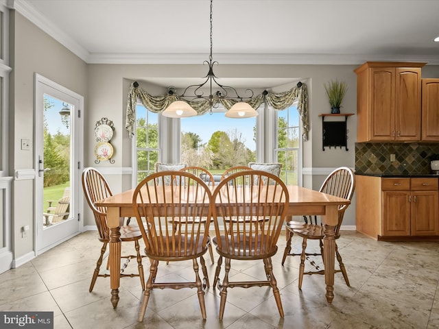 dining space with a chandelier, crown molding, and light tile patterned flooring