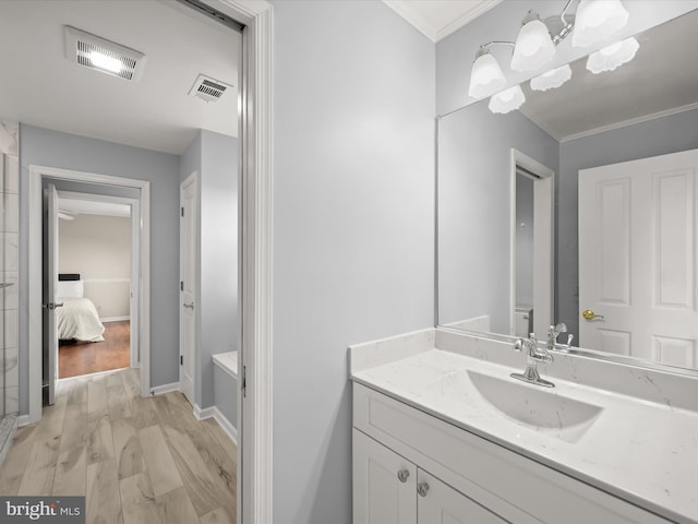bathroom with baseboards, ornamental molding, vanity, and visible vents