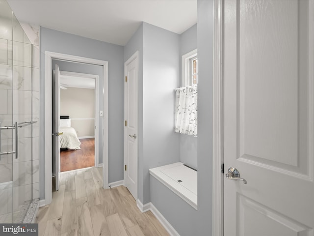 interior space with baseboards and light wood-style flooring