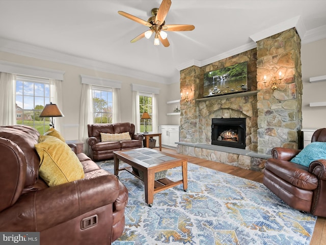 living room featuring a ceiling fan, ornamental molding, wood finished floors, and a healthy amount of sunlight