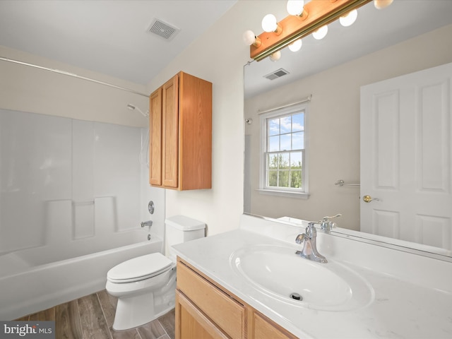 bathroom featuring wood finished floors, visible vents, vanity, and toilet