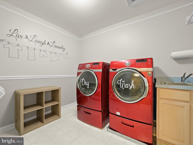 laundry room with separate washer and dryer, cabinet space, and a sink