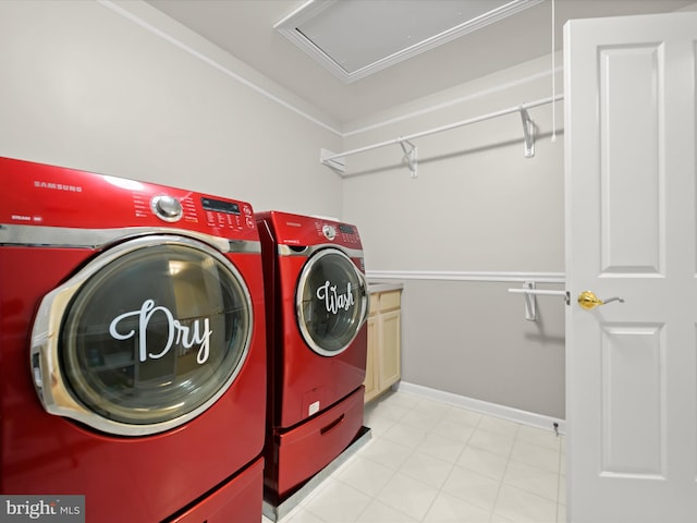 clothes washing area with crown molding, baseboards, cabinet space, and washer and clothes dryer