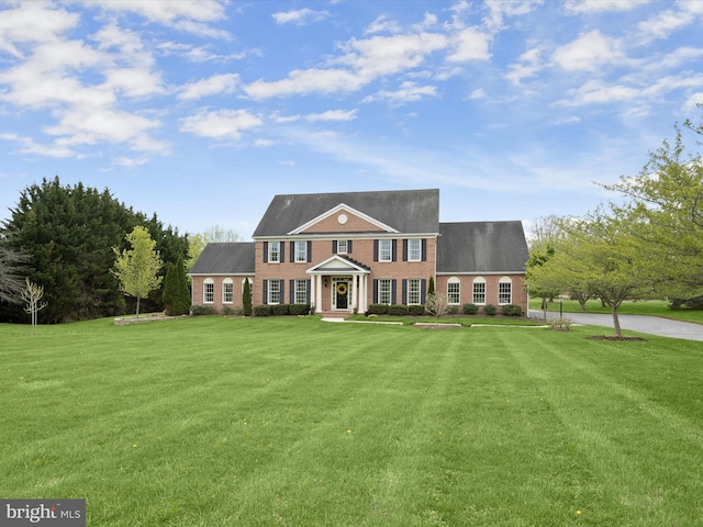 view of front of property with brick siding and a front yard