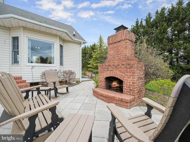 view of patio featuring an outdoor brick fireplace