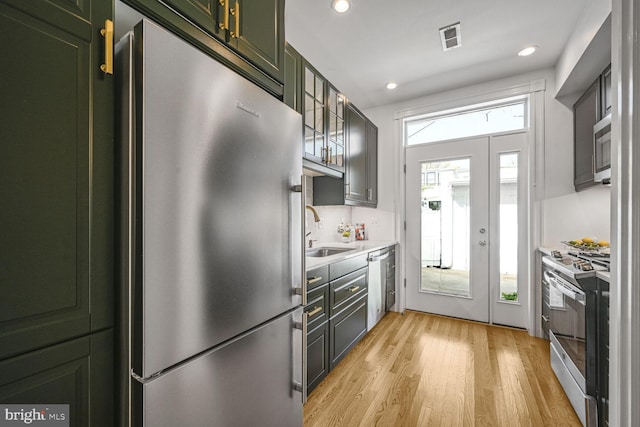 314 14th Pl NE, Washington, DC 20002 - kitchen with light wood-style flooring, visible vents, a sink, stainless steel appliances, and green cabinetry