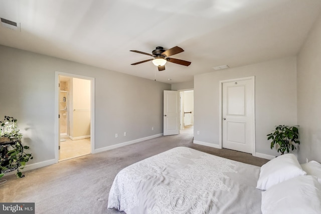 bedroom featuring carpet flooring, baseboards, ensuite bathroom, and a ceiling fan