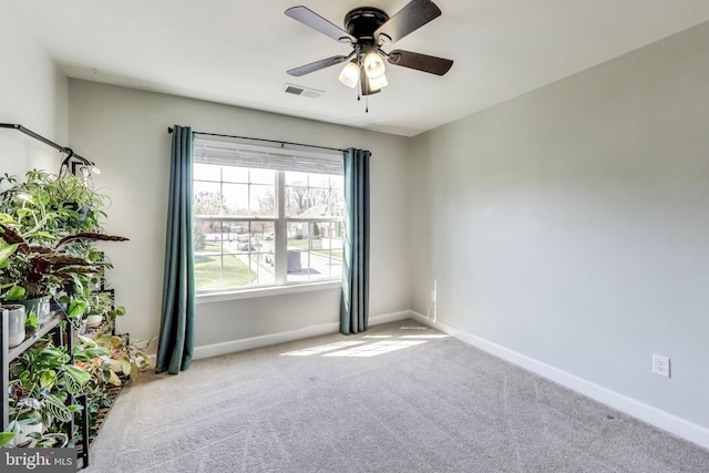 unfurnished room featuring a ceiling fan, carpet flooring, and baseboards