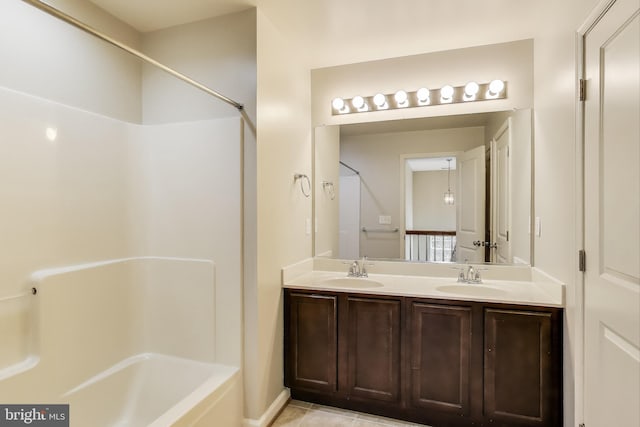 bathroom with double vanity, tile patterned floors, and bathing tub / shower combination