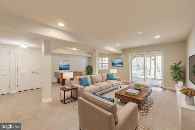 living area featuring baseboards, light carpet, and recessed lighting