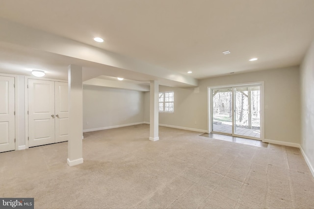 below grade area featuring light colored carpet, baseboards, and recessed lighting