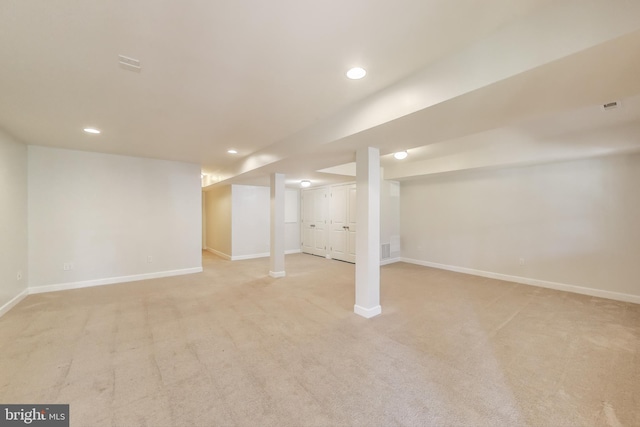 finished below grade area with light colored carpet, baseboards, and recessed lighting