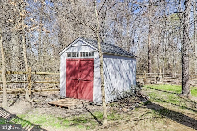 view of shed featuring fence