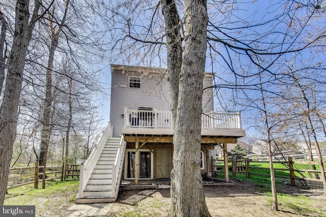 back of house with stairway, a wooden deck, fence, and a chimney