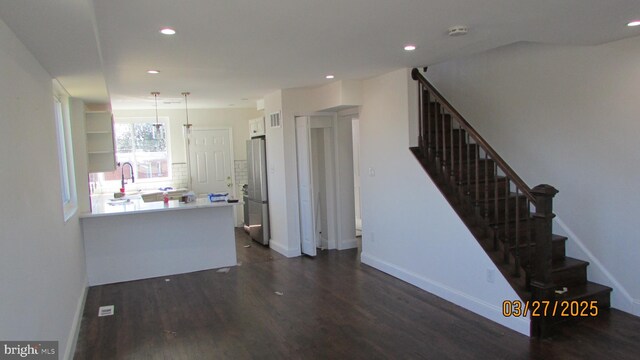 1261 Gallatin St NE, Washington, DC 20017 - interior space with freestanding refrigerator, dark wood-style flooring, a peninsula, and recessed lighting