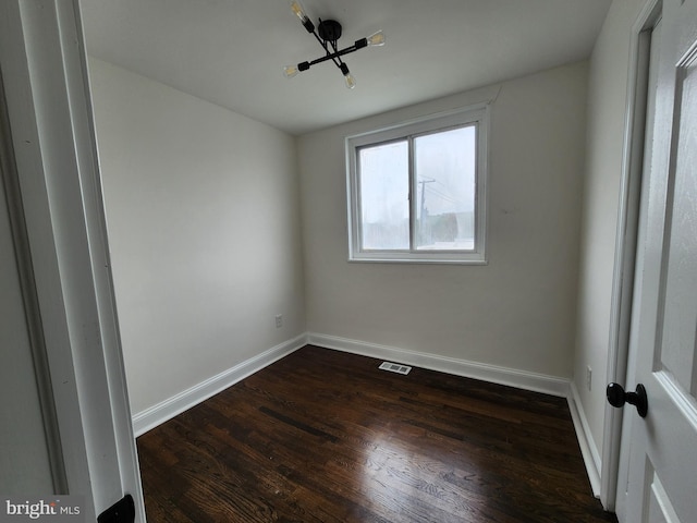 1261 Gallatin St NE, Washington, DC 20017 - unfurnished room with baseboards, dark wood-style flooring, and visible vents