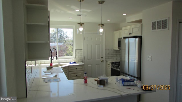 1261 Gallatin St NE, Washington, DC 20017 - kitchen featuring a peninsula, tasteful backsplash, appliances with stainless steel finishes, and visible vents