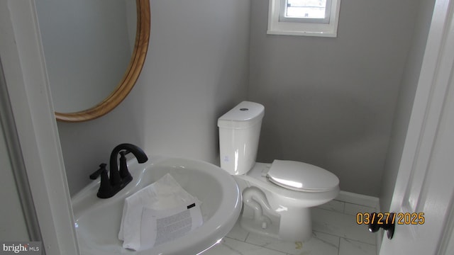 1261 Gallatin St NE, Washington, DC 20017 - half bath featuring baseboards, marble finish floor, a sink, and toilet